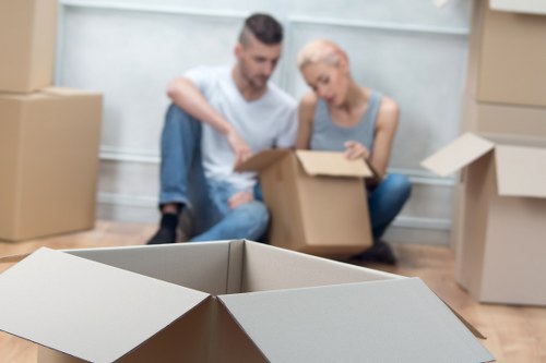 Packed office boxes and desks ready for commercial relocation in Purley